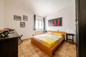 a bedroom with a bed and a desk in it at La piccionaia - Le Case del Dria - Roof terrace in Genova