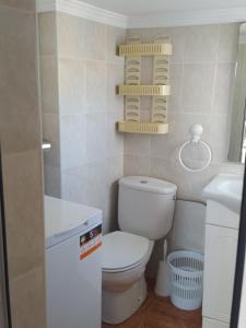 a small bathroom with a toilet and a sink at Casa El Barco in Torrox +13 photos