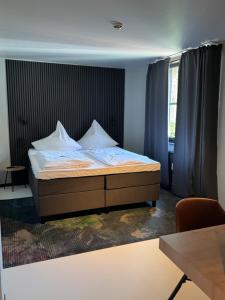 Säng eller sängar i ett rum på Hotel Zur Mühle