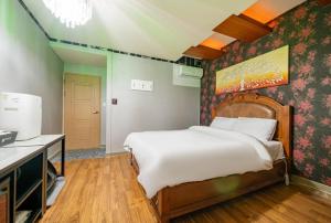 a bedroom with a large bed in a room at Andong hotel in Andong