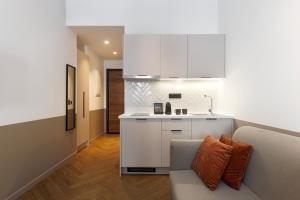 a living room with a couch and a kitchen at ERMASS Athens in Athens