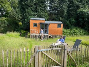 a couple of people sitting in front of a tiny house at Joly Tiny House in Overijse