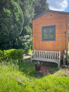 a bench sitting in front of a small building at Joly Tiny House in Overijse