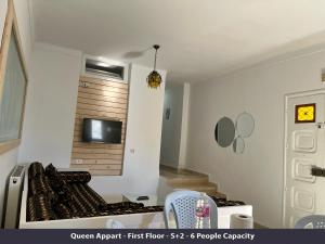 a kitchen with a stove and a tv on the wall at Tunisia Queen Apartment in Hammamet +45 photos