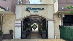 a entrance to a building with a sign on it at Stamopolulux директен изглед към морето in Primorsko