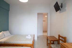 A bed or beds in a room at Manos Kritikakis Apartments