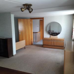 a living room with a mirror and a dresser at geräumiges Ferienhaus in Beverungen
