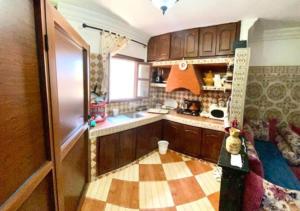 a kitchen with wooden cabinets and a refrigerator at Apartment in Safi Top Near the Sea, Morocco in Safi