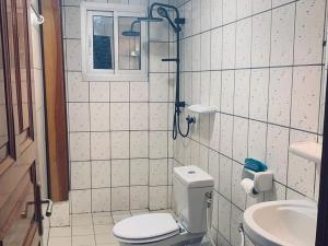 a bathroom with a toilet and a sink at Douala Cityscape Apartment, Bonamoussadi, Douala, Cameroon - ACE in Bonamoussadi +3 photos