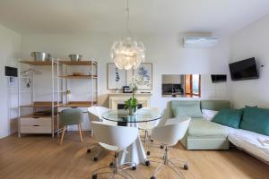 a living room with a table and a couch at Appartamento Marina in Stresa