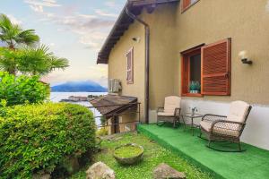 a patio with two chairs and a view of the water at Appartamento Marina in Stresa
