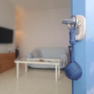 a hospital room with a hospital bed and a blue door at Ithaca in Perdika