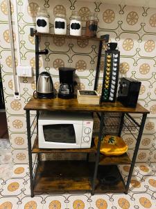 a table with a microwave on top of it at Roma Manuela'S Cozy Guest House Trastevere in Rome