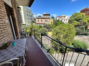 a balcony with a table and a view of a city at Roma Manuela'S Cozy Guest House Trastevere in Rome