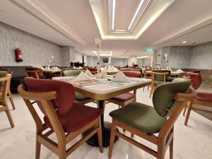 a dining room with a table and chairs at فندق مادن طيبة MADEN Taiba HOTEL in Al Madinah