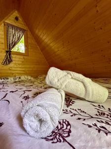 a bedroom with a bed with towels on it at Glamping Krn in Kobarid