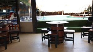 a restaurant with tables and chairs in front of a pool at LAKE-HOUSE CABIN in eMalahleni
