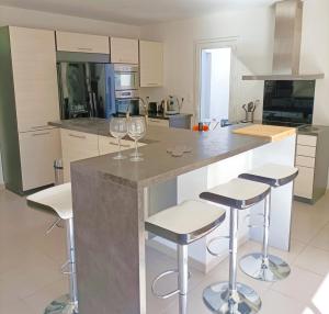 a kitchen with two wine glasses on a counter at Villa "Agathe" - 10 guests in Calvisson