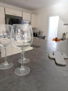 three wine glasses sitting on a counter in a kitchen at Villa "Agathe" - 10 guests in Calvisson