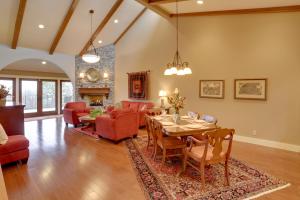 a living room with a table and chairs and a fireplace at Beautiful Central Fayetteville Townhome with Views! in Fayetteville