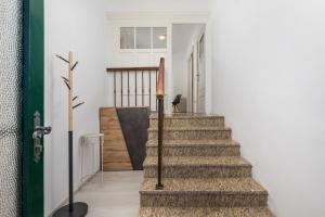 a staircase in a house with a green door at Nada apartment in Rijeka