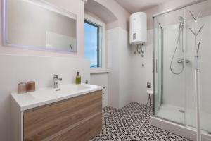 a bathroom with a sink and a shower at Nada apartment in Rijeka