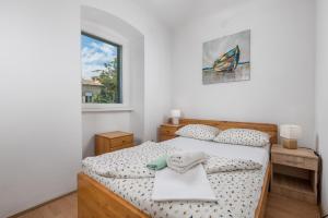 a bedroom with a bed and a window at Nada apartment in Rijeka