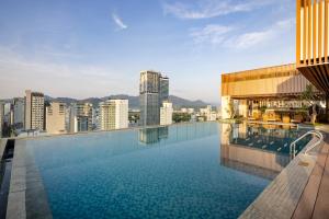 a swimming pool on the roof of a building at Gonsala Hotel Nha Trang in Nha Trang