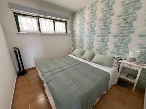 a bedroom with a bed and a desk and a window at Las Torres del Castillo, 108Cactus in Costa de Antigua +39 photos