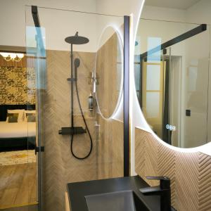 a bathroom with a shower with a sink at Hotel Le Twelve in Paris