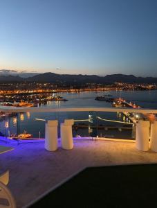 a view of a marina at night with white pillars at La casa de Pernilla Awesome apartment, near beach in centre of town in Puerto de Mazarrón