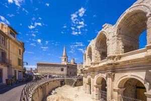 a view of the colosseum with a church in the background at Nicolaï Arles centre in Arles