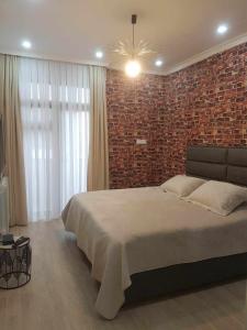 Postel nebo postele na pokoji v ubytování Batumi Lux