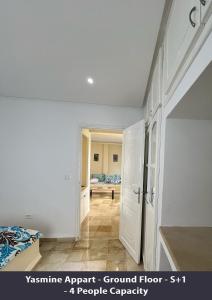 a bedroom with a bed and a doorway into a room at Tunisia Queen Apartment in Hammamet