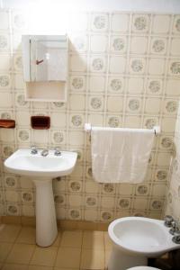a bathroom with a white sink and a toilet at Apart Hotel Río Dulce in Termas de Río Hondo