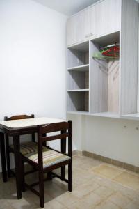 a table and a chair in a room at Apart Hotel Río Dulce in Termas de Río Hondo