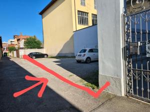 a red line on the side of a building next to a gate at Casa liberty style in Milan