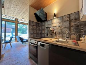 a kitchen with a sink and a counter top at La cour des secrets - gitesdanslain in Pont-dʼAin