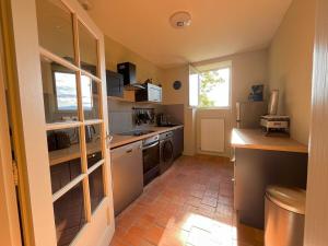 a kitchen with a sink and a stove top oven at Le repaire de l'écuyer in Pont-dʼAin