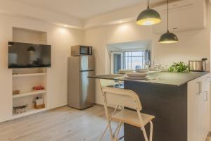a kitchen with a counter and a refrigerator at Casa Bambina in Varenna +27 photos