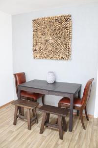 a dining room table and chairs with a picture on the wall at Ubytování Němčičky in Němčičky