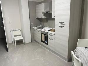 a kitchen with a stove and a stove top oven at Alysia House in Naples