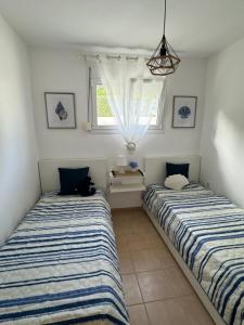 two beds sitting next to each other in a room at Siviri Holiday Home in Siviri