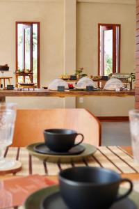 a table with two cups on top of it at Terrasa Solar Hotel in Icaraí +28 photos