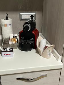 a counter top with a coffee maker and other kitchen items at Alysia House in Naples