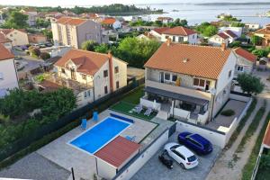 an aerial view of a house with a swimming pool at Royal place in Nin