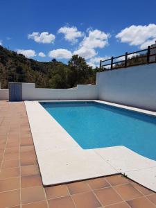 a swimming pool on the side of a house at Finca Las Minas in Iznájar +22 photos