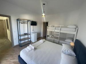 a room with two bunk beds and a mirror at Vanesa Rooms in Sarandë