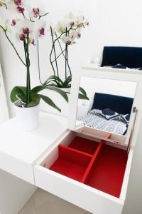 a drawer in a white desk with a plant at La Rosa di Capri in Capri