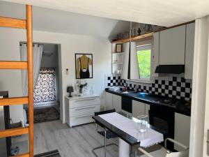 a kitchen with black and white tiles on the wall at Art Gallery suite in Vantačići